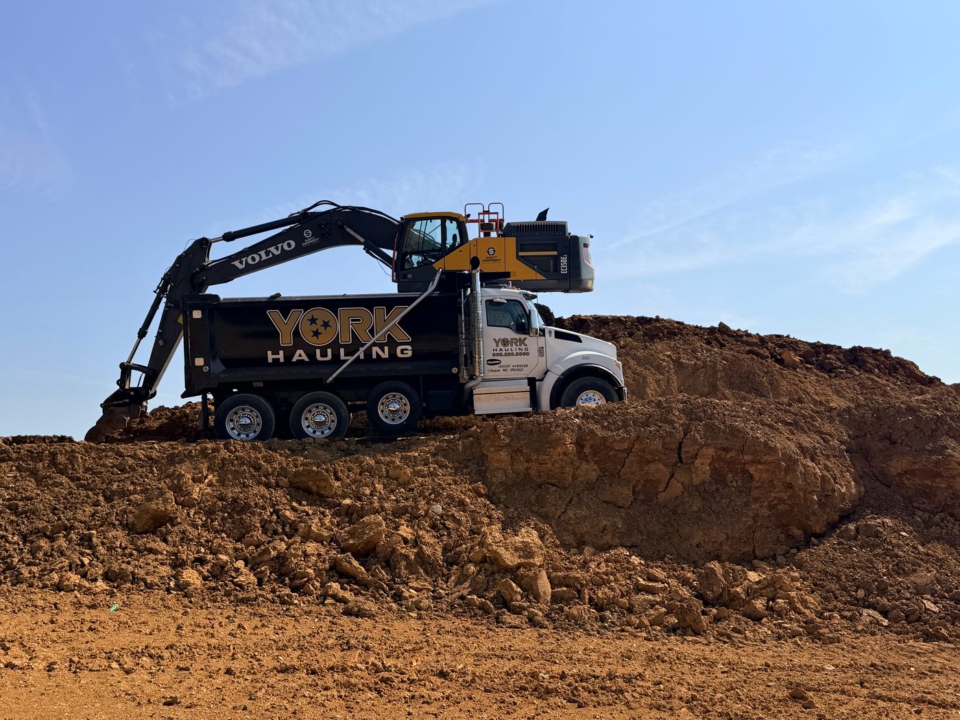 York Hauling dump truck being loaded on a job site